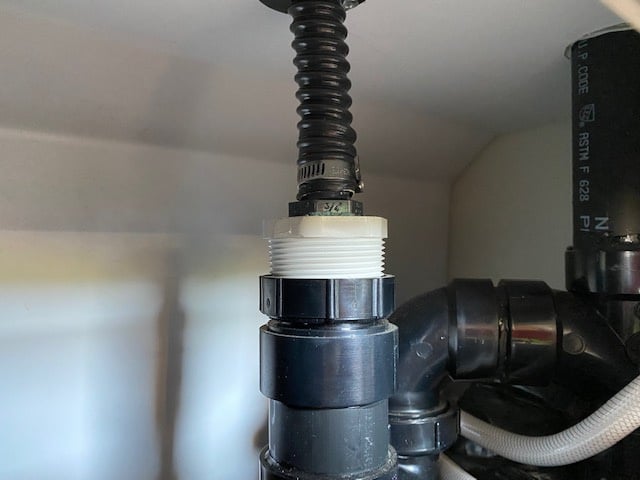 Drain from folding sink behind outdoor shower.jpeg