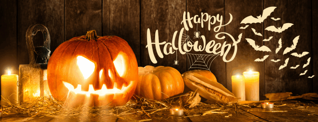 Happy halloween. A picture of pumpkins and candles in a dark barn with bats