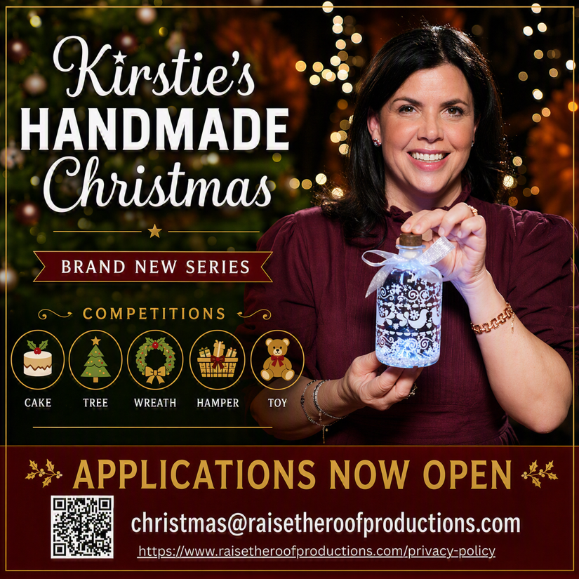 A picture of a white woman with brown hair holding a tree decoration and smiling.
