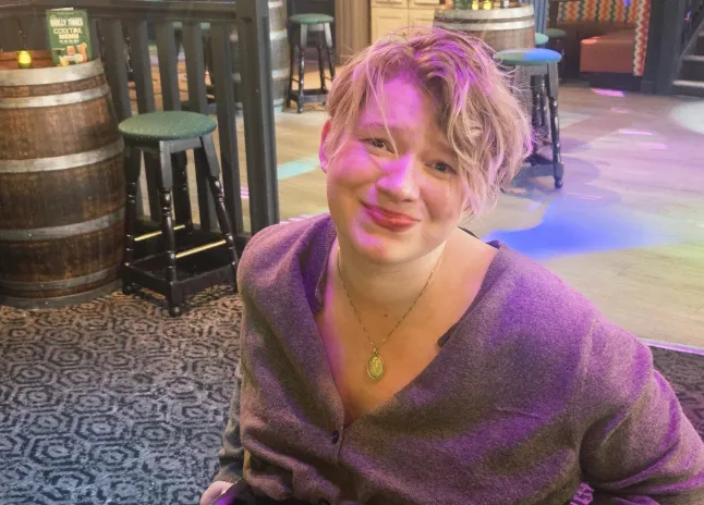 Melissa Parker in a bar, smiling at the camera