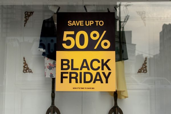 a sale sign saying save up to 50 per cent on top and black Friday at the bottom