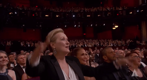 Meryl Streep standing at the Oscars and applauding