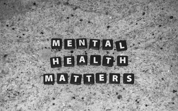 tiles spelling out mental health matters on a table