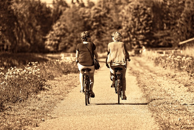 two women riding bikes outdoors