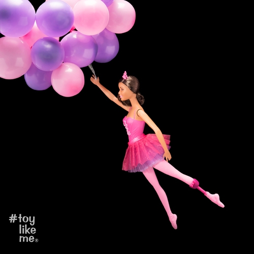 Barbie doll being pulled away by balloons