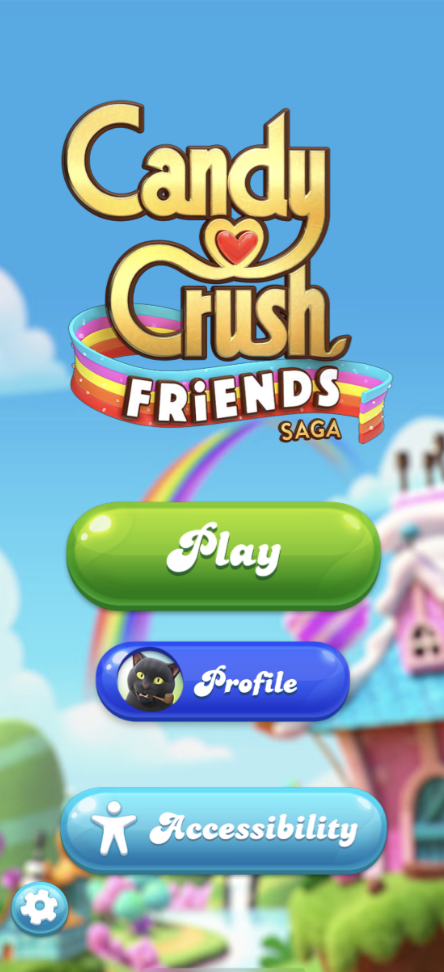 Main menu of 'Candy Crush Friends Saga' displaying options for 'Play,' 'Profile,' and 'Accessibility' against a backdrop of a whimsical candy-themed landscape.