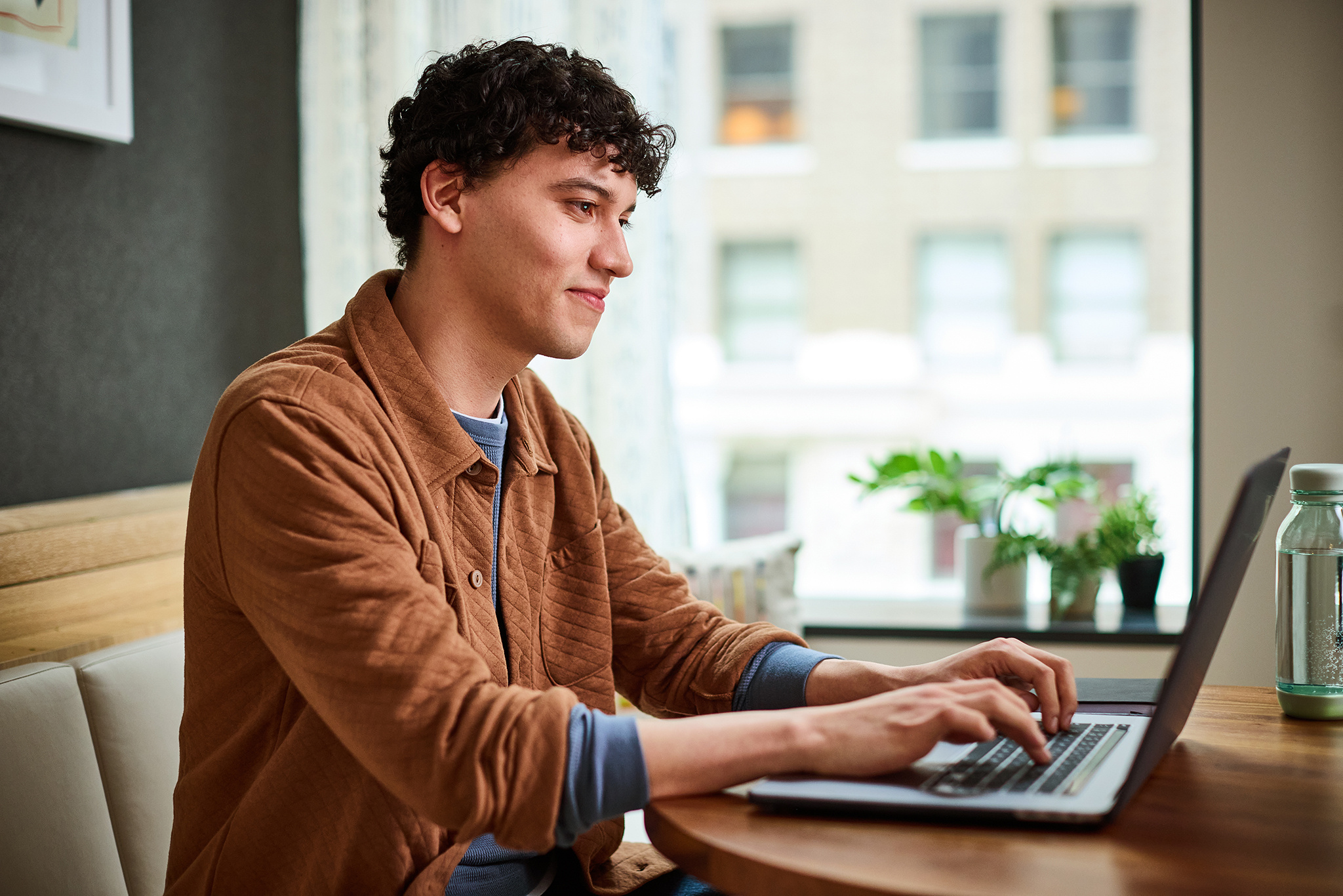 Man smiling at his laptop