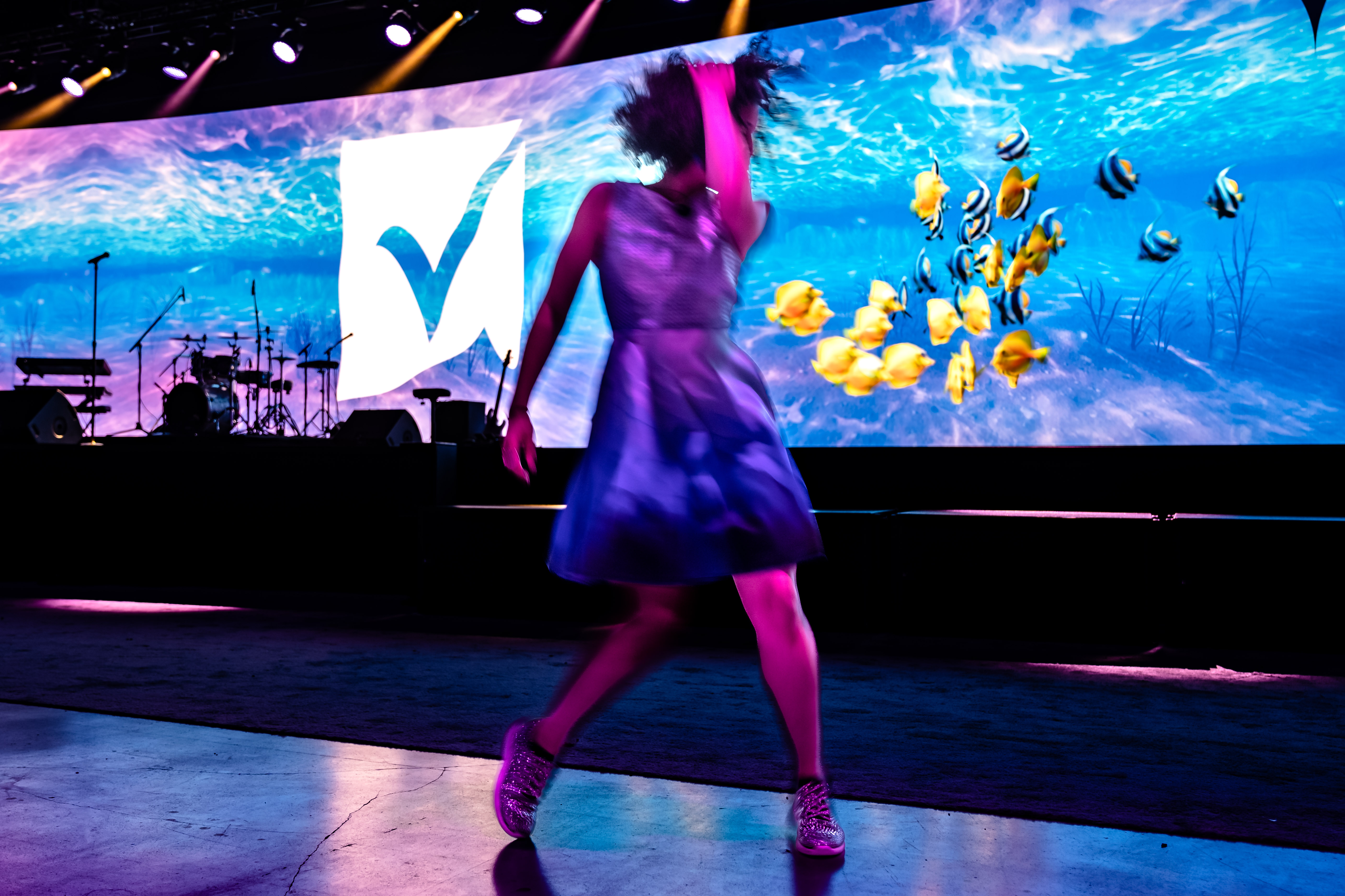 A woman dances in front of the stage at ENGAGE