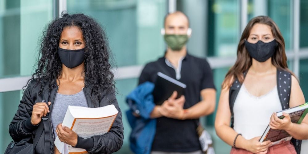 mixed-ethnicity-students-wearing-masks-on-campus-picture-id1256757902 (2).jpg