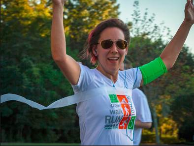 Jennifer Deman crosses the finish line of the Walk/Run/Crawl Support 5K