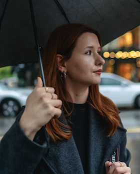 Portrait of Karen Barren holding an umbrella