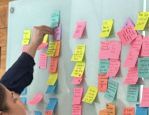 Sticky notes of ideas being organized and grouped by vote