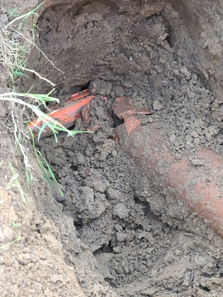 Orange conduit/cable going through sewer