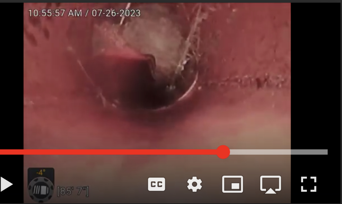 Orange conduit/cable going through sewer from inside sewer pipe