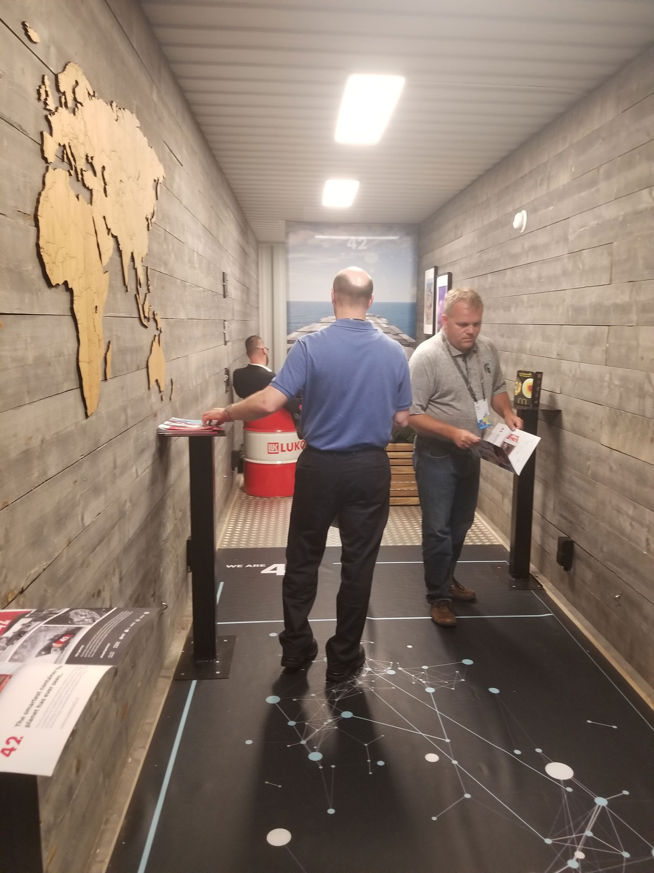 UC attendees meet and walk through the shipping container.